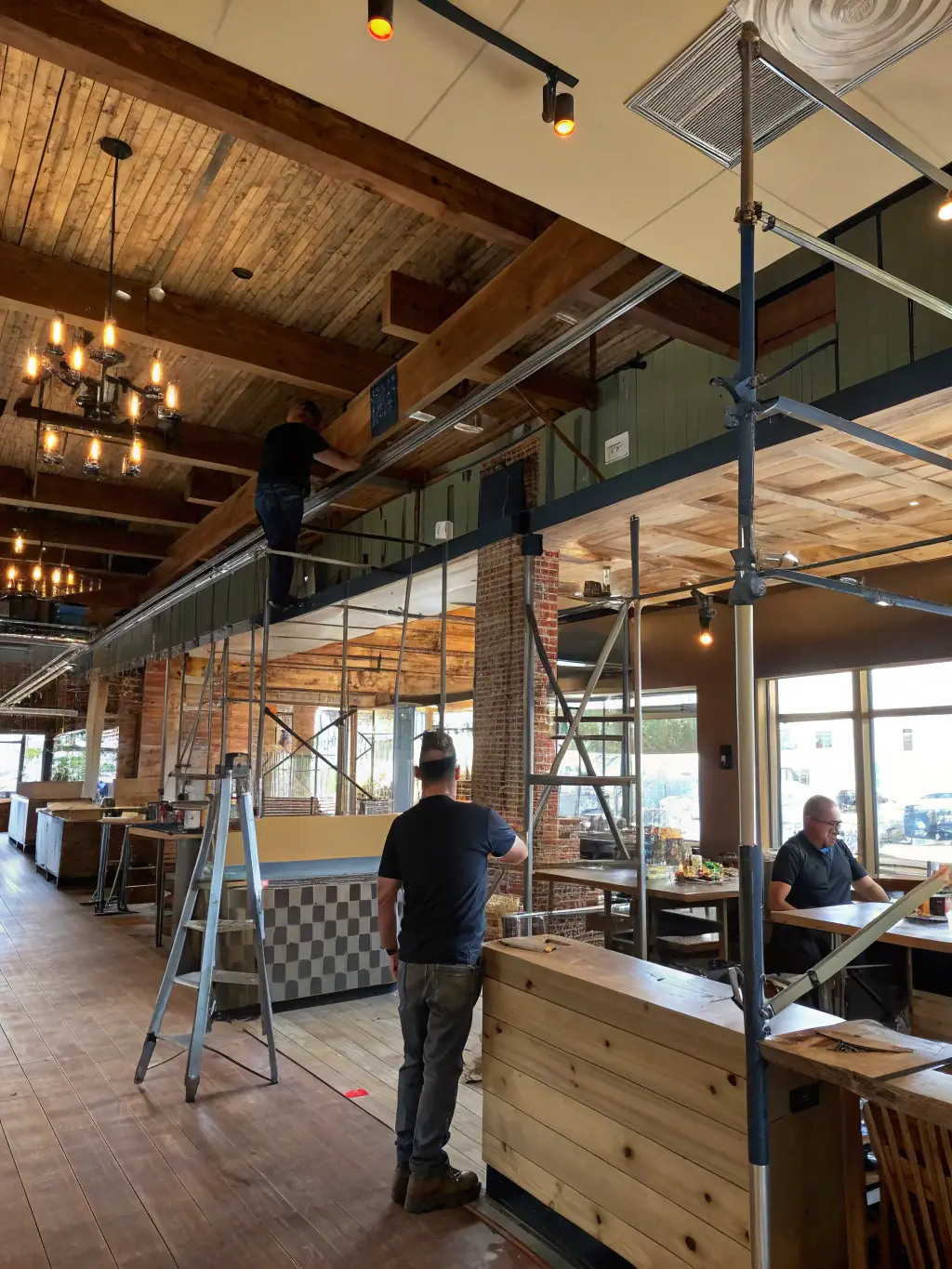 An interior shot of a commercial office space under construction, with exposed ductwork, electrical wiring, and metal framing, showcasing Evan & Co. Construction's expertise in commercial projects.